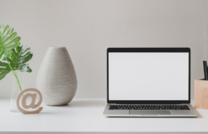 modern desktop with laptop and vase