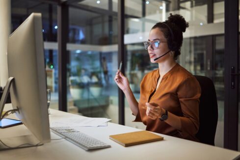 Insurance agent wearing headset speaking on video call