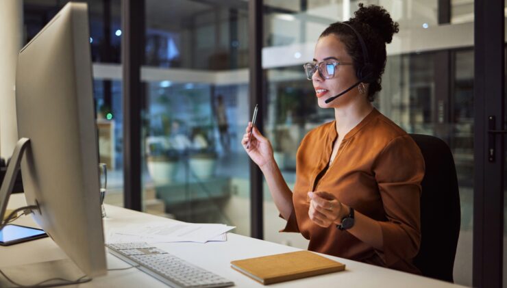 Insurance agent wearing headset speaking on video call